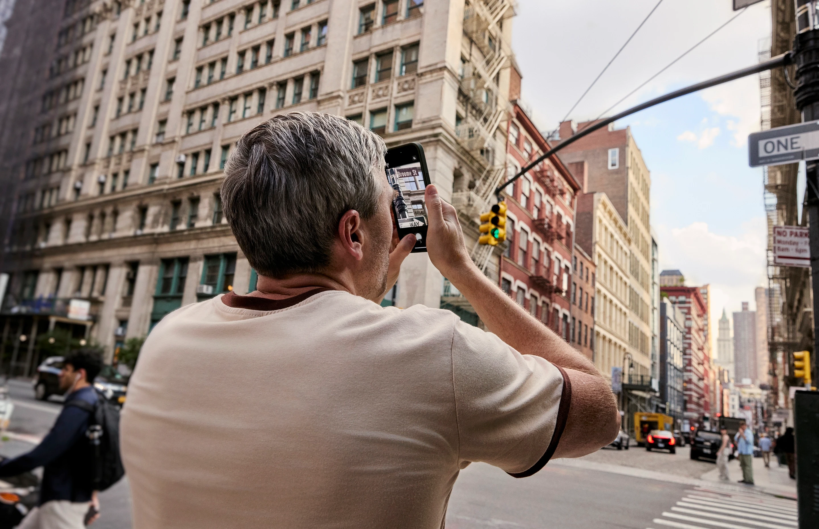 A man filming a busy New York street with his phone