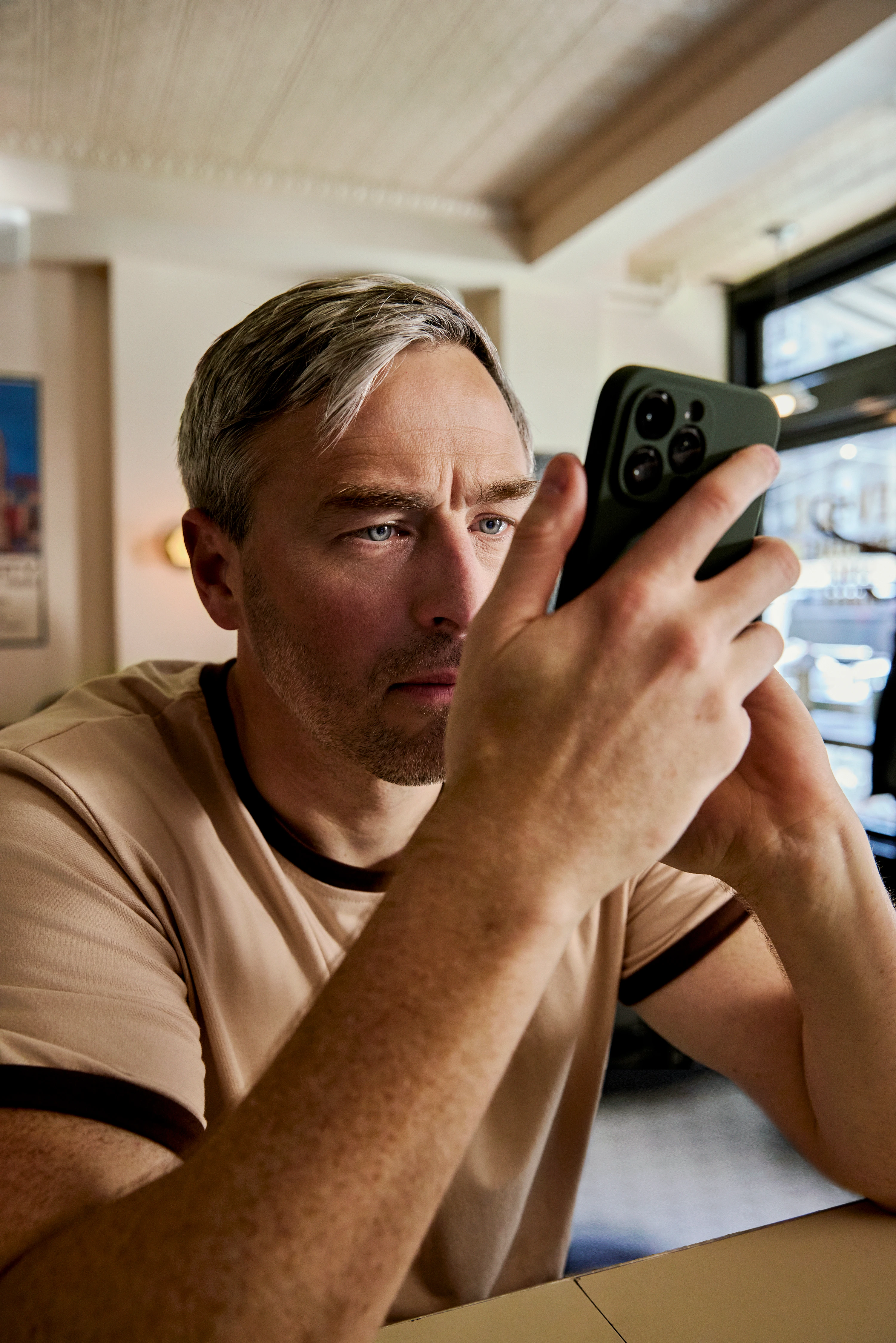 Close-up of a man concentrating on his phone screen